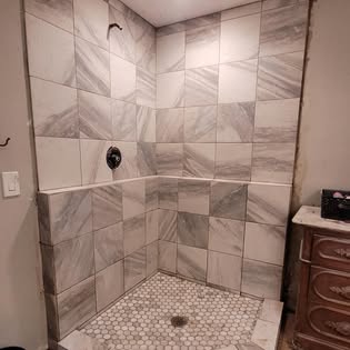 Marble-look tile shower build by Hammer Down Construction